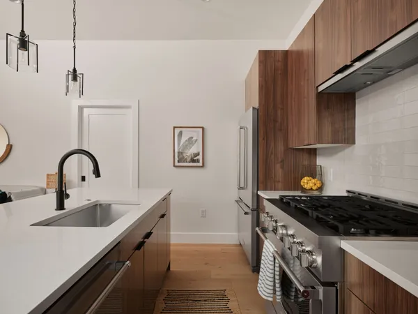 a kitchen with stainless steel appliances a sink a stove and a refrigerator