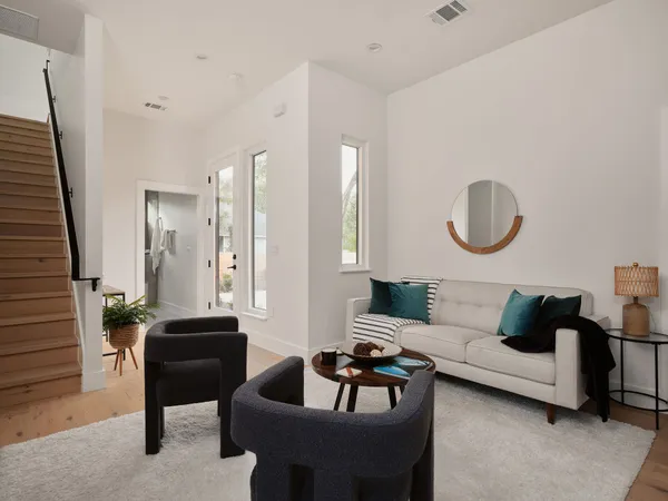 a living room with furniture rug and lamp