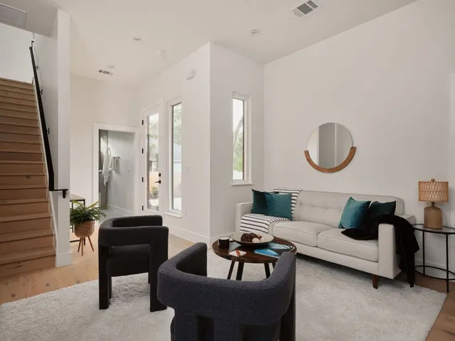 a living room with furniture and a potted plant