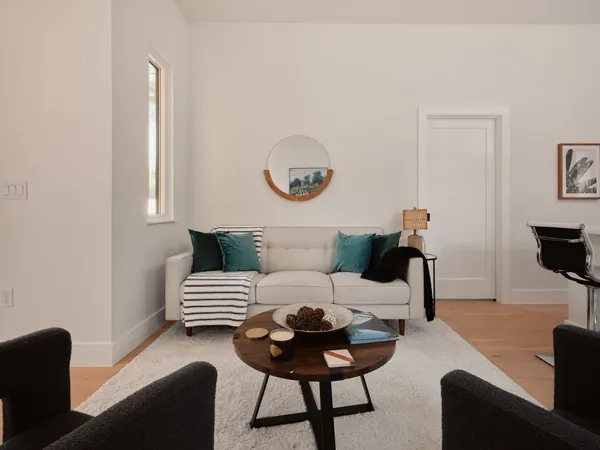 a living room with furniture and wooden floor