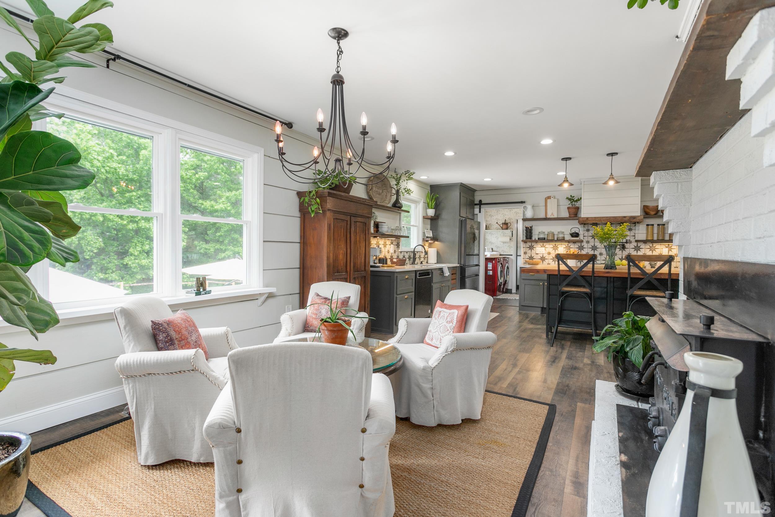 238 Alston Road Apex, NC 27523 - Photo 20 of 50 a living room with furniture and a chandelier