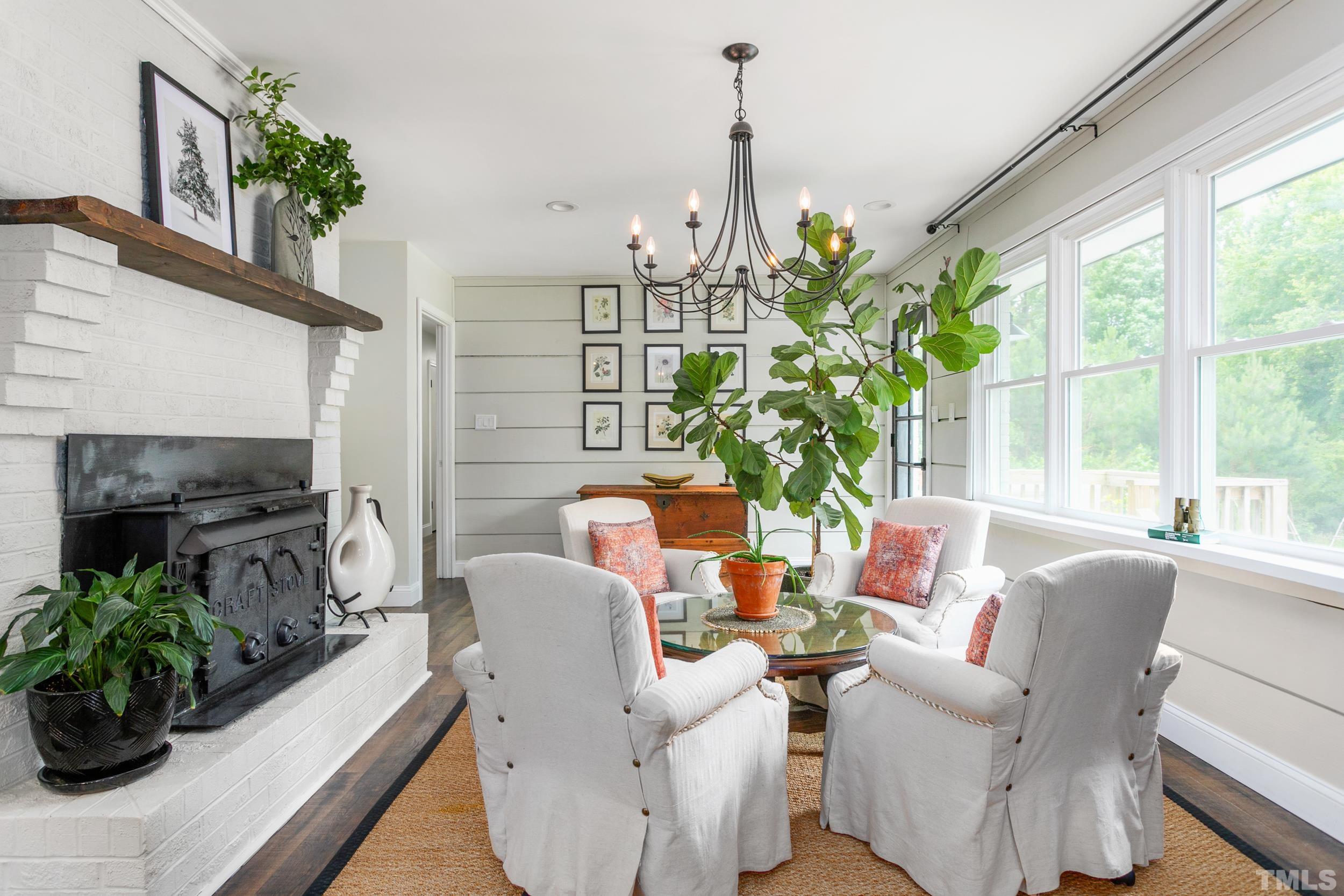 238 Alston Road Apex, NC 27523 - Photo 23 of 50 a living room with furniture a chandelier and a window