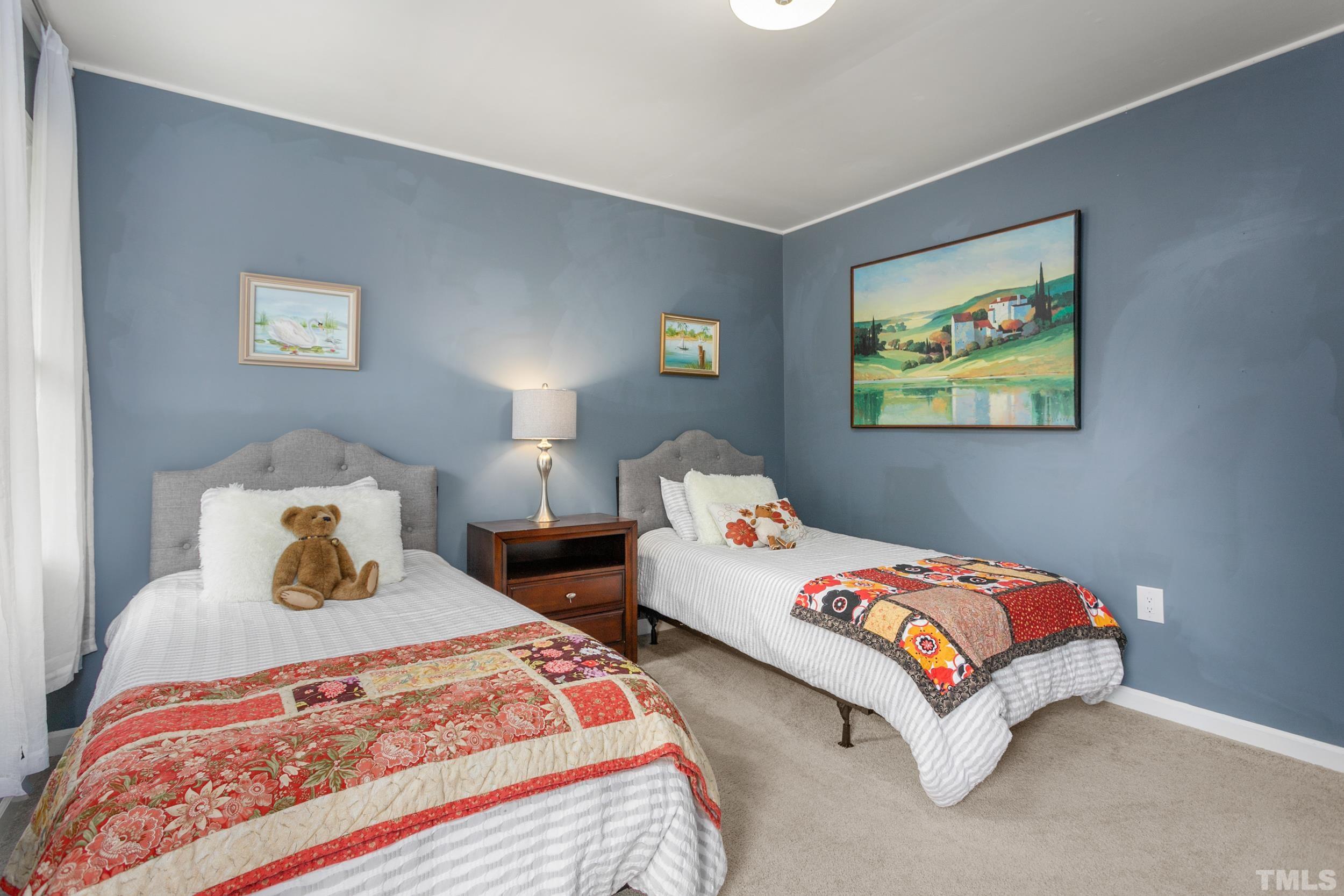 238 Alston Road Apex, NC 27523 - Photo 27 of 50 a bedroom with two beds and painting on the wall