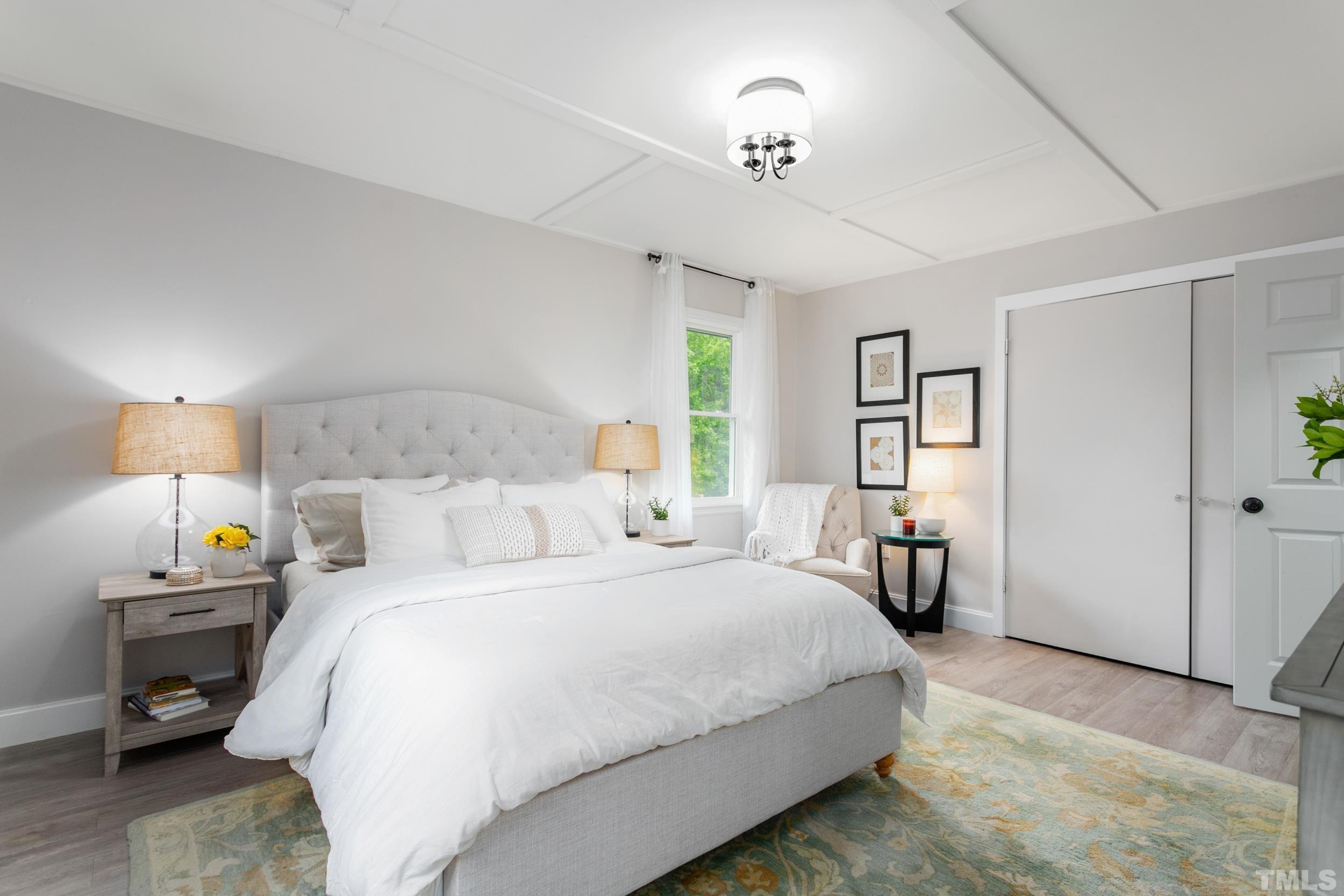 238 Alston Road Apex, NC 27523 - Photo 29 of 50 a bedroom with a bed and a chandelier