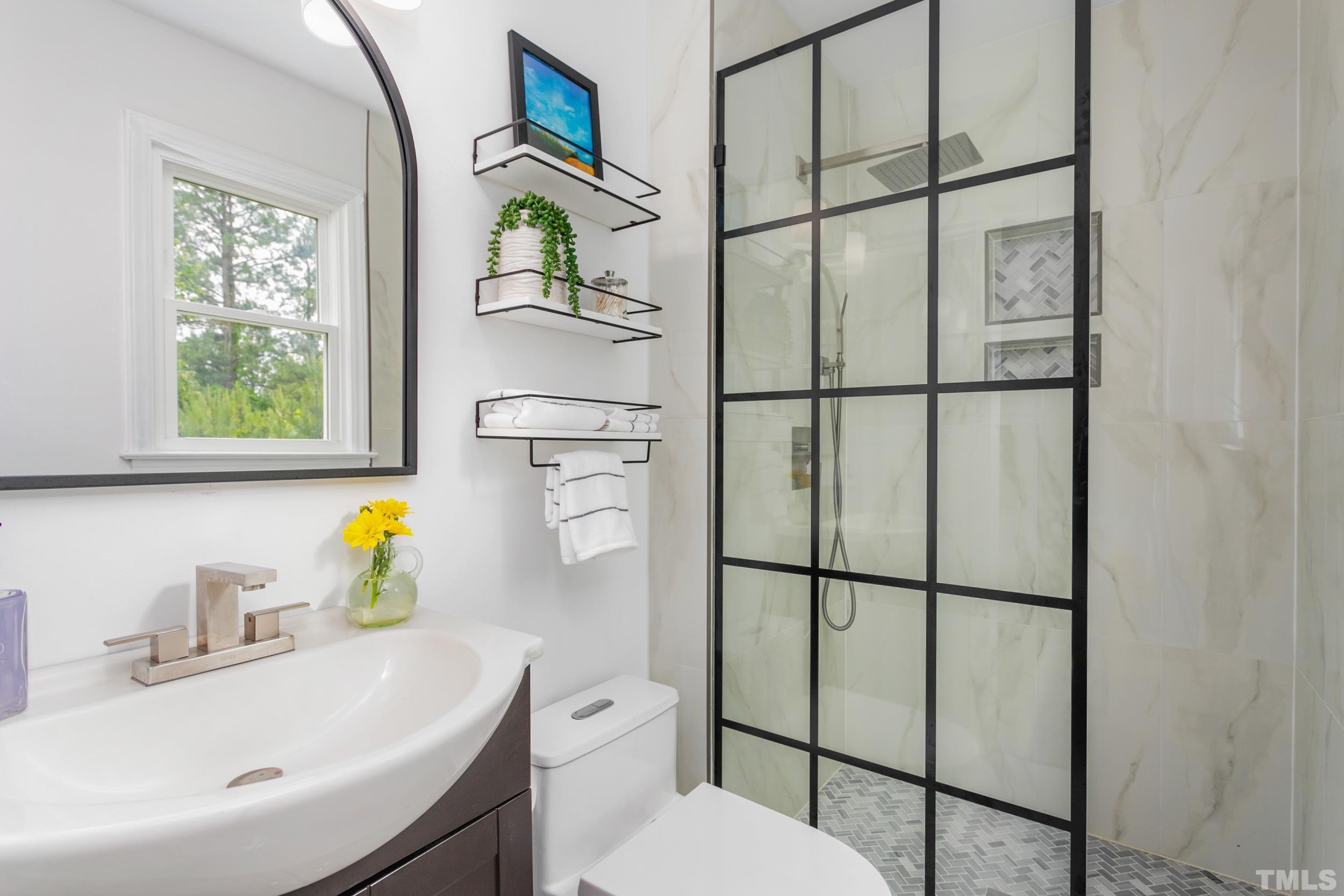 238 Alston Road Apex, NC 27523 - Photo 30 of 50 a bathroom with a sink toilet and window