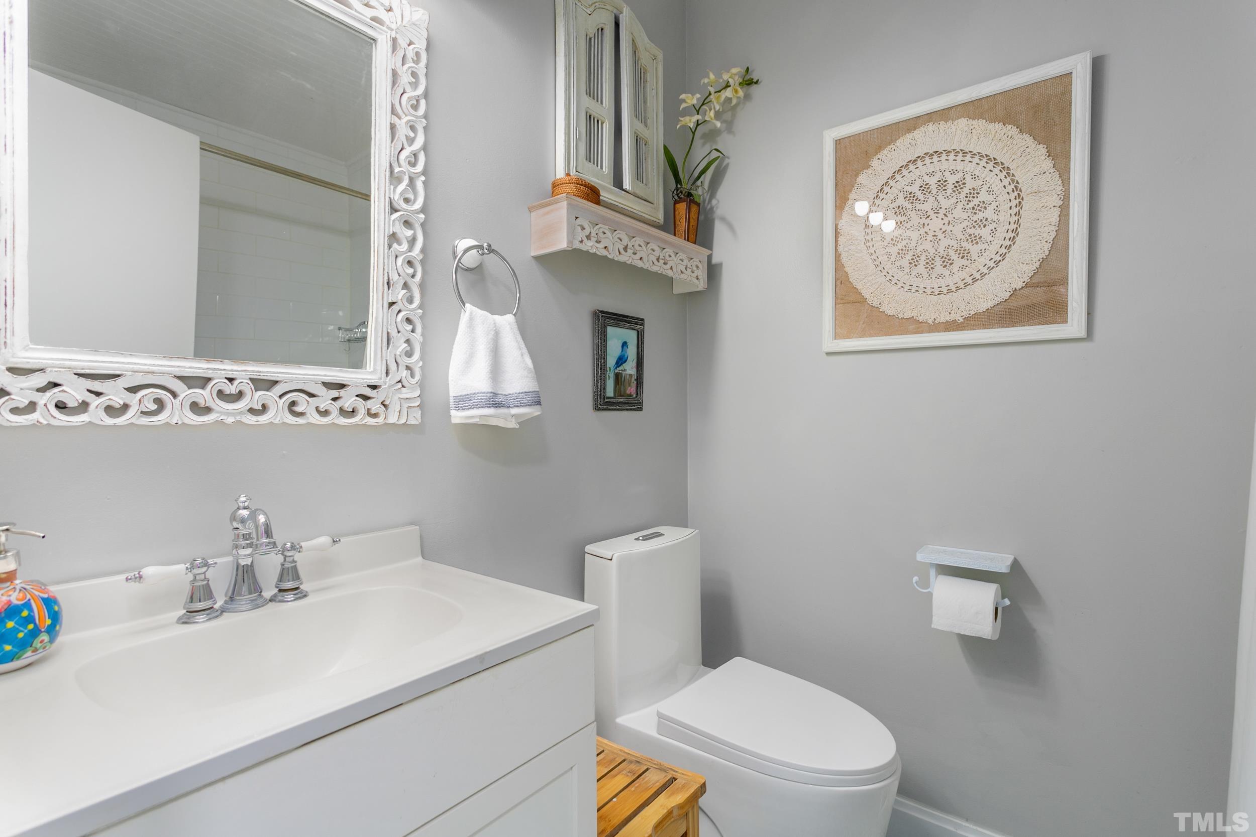 238 Alston Road Apex, NC 27523 - Photo 31 of 50 a bathroom with a toilet a sink and a mirror