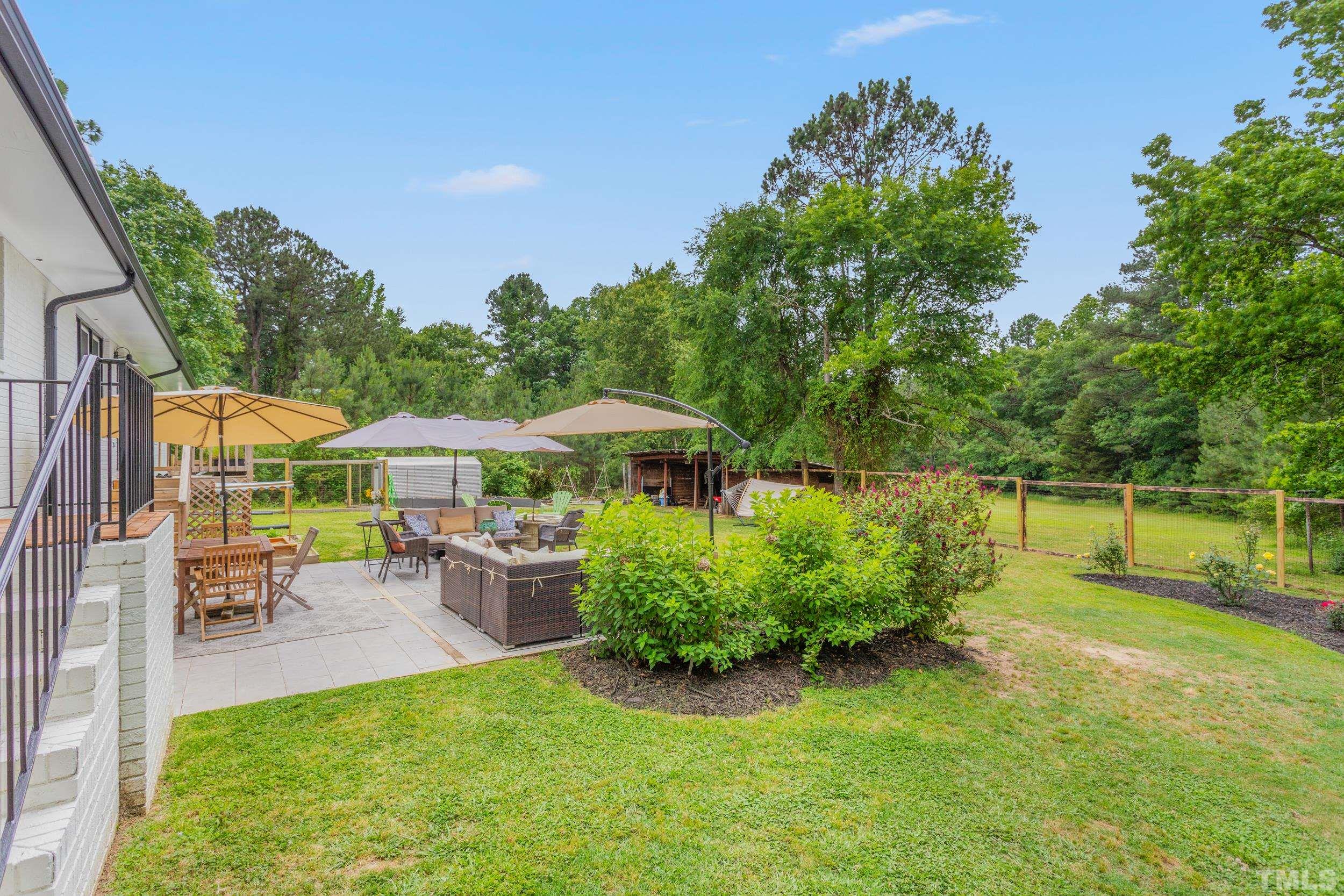 238 Alston Road Apex, NC 27523 - Photo 34 of 50 a view of a garden with a bench in patio