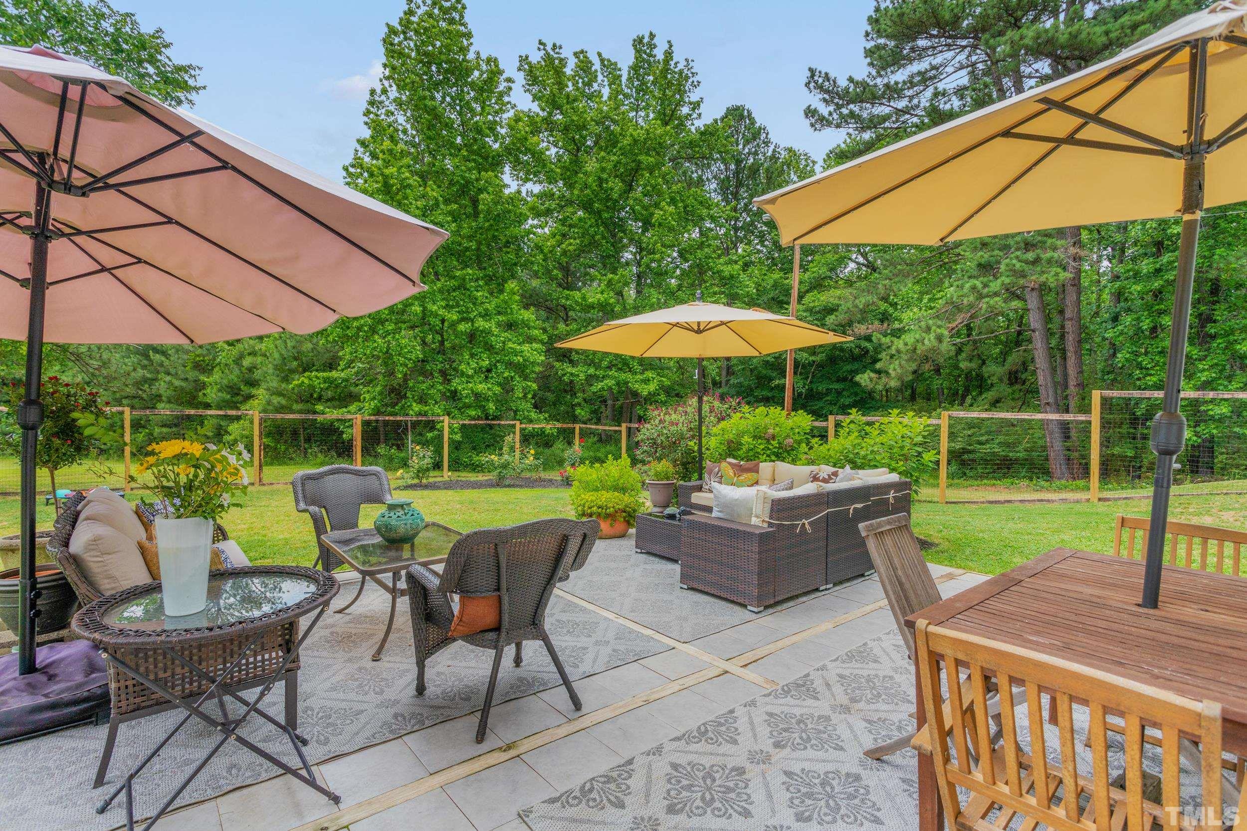 238 Alston Road Apex, NC 27523 - Photo 36 of 50 a view of backyard with seating space and wooden fence