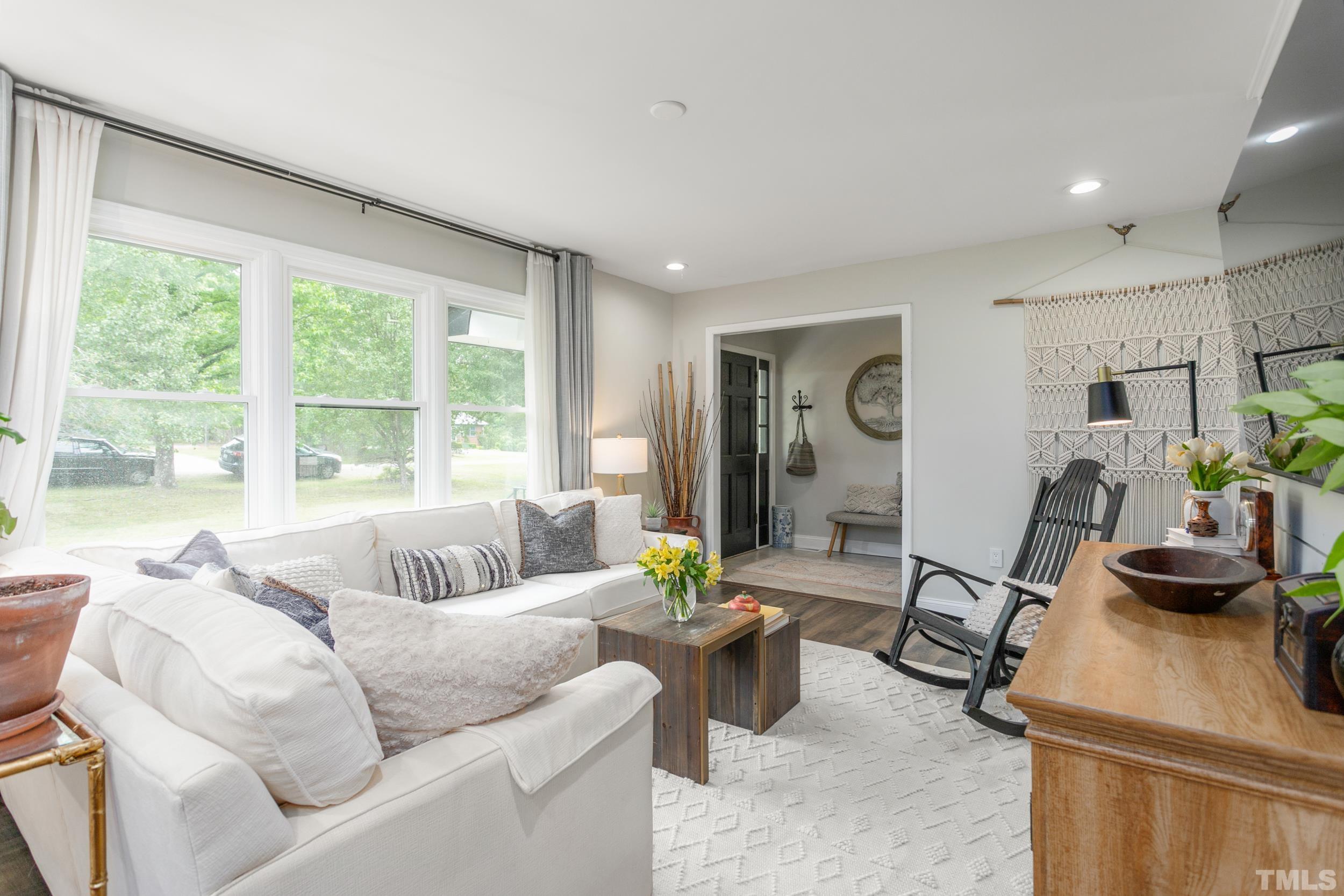238 Alston Road Apex, NC 27523 - Photo 9 of 50 a living room with furniture and floor to ceiling windows