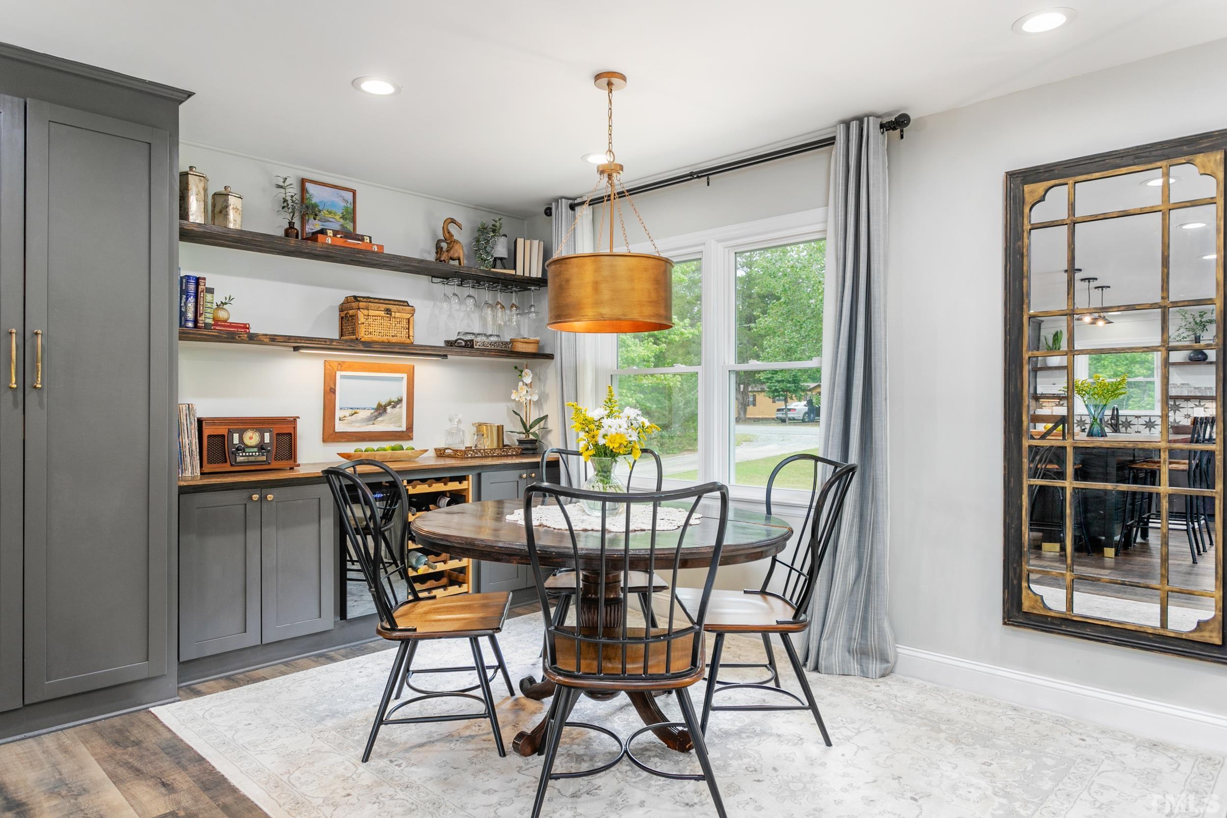 238 Alston Road Apex, NC 27523 - Photo 10 of 50 a view of a dining room with furniture and a window