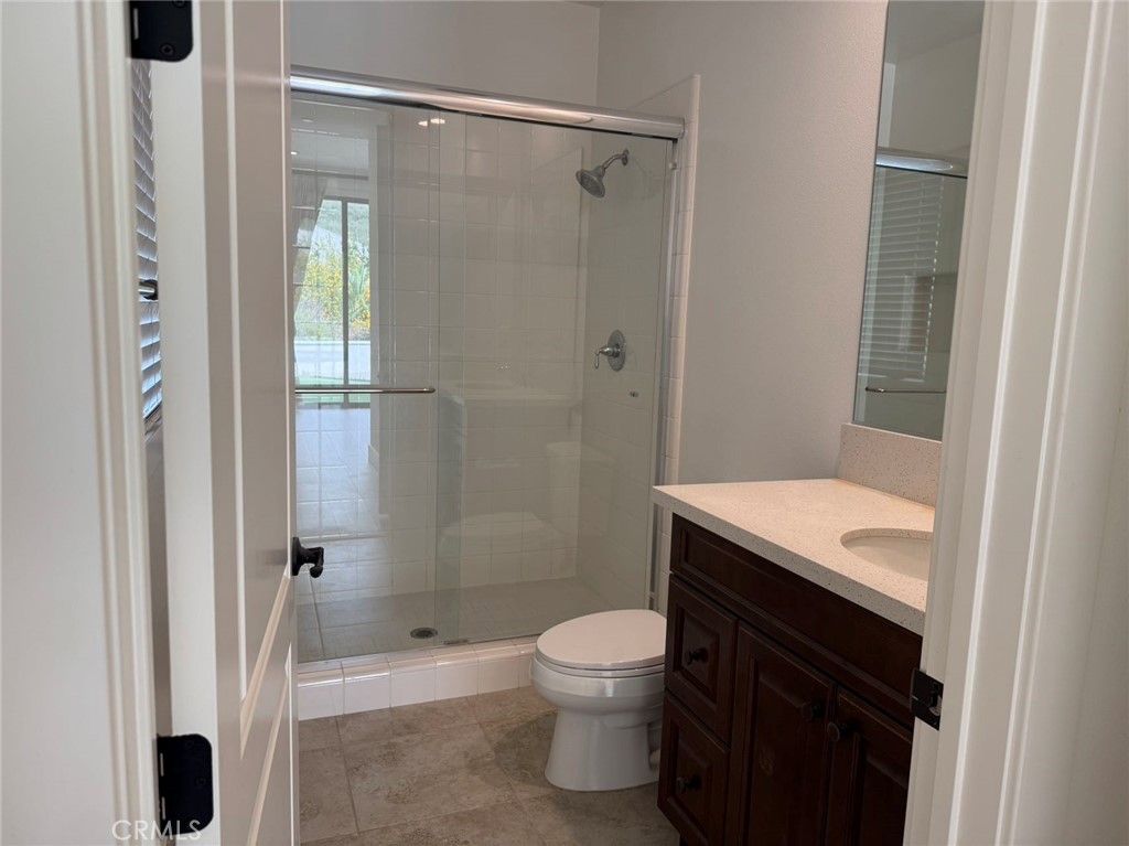 101 Interstellar Irvine, CA 92618 - Photo 11 of 24 a bathroom with a granite countertop sink a toilet and shower