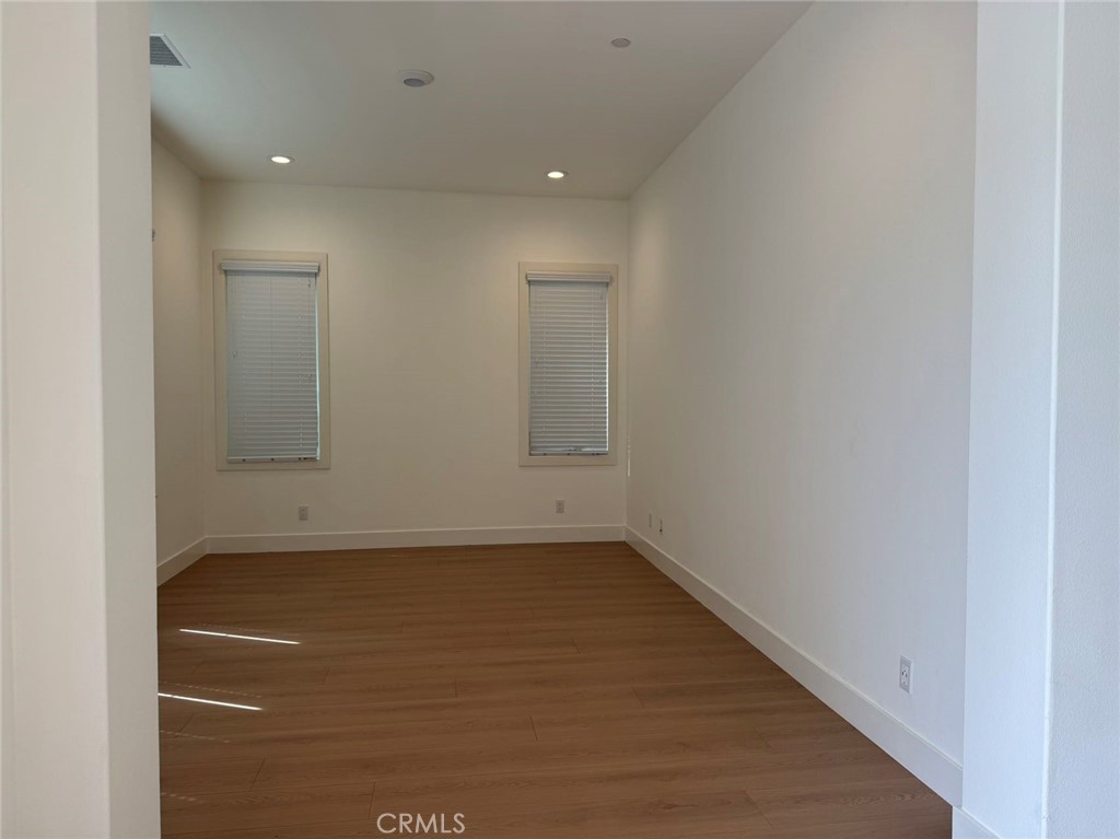 101 Interstellar Irvine, CA 92618 - Photo 14 of 24 a view of a room with wooden floor and window