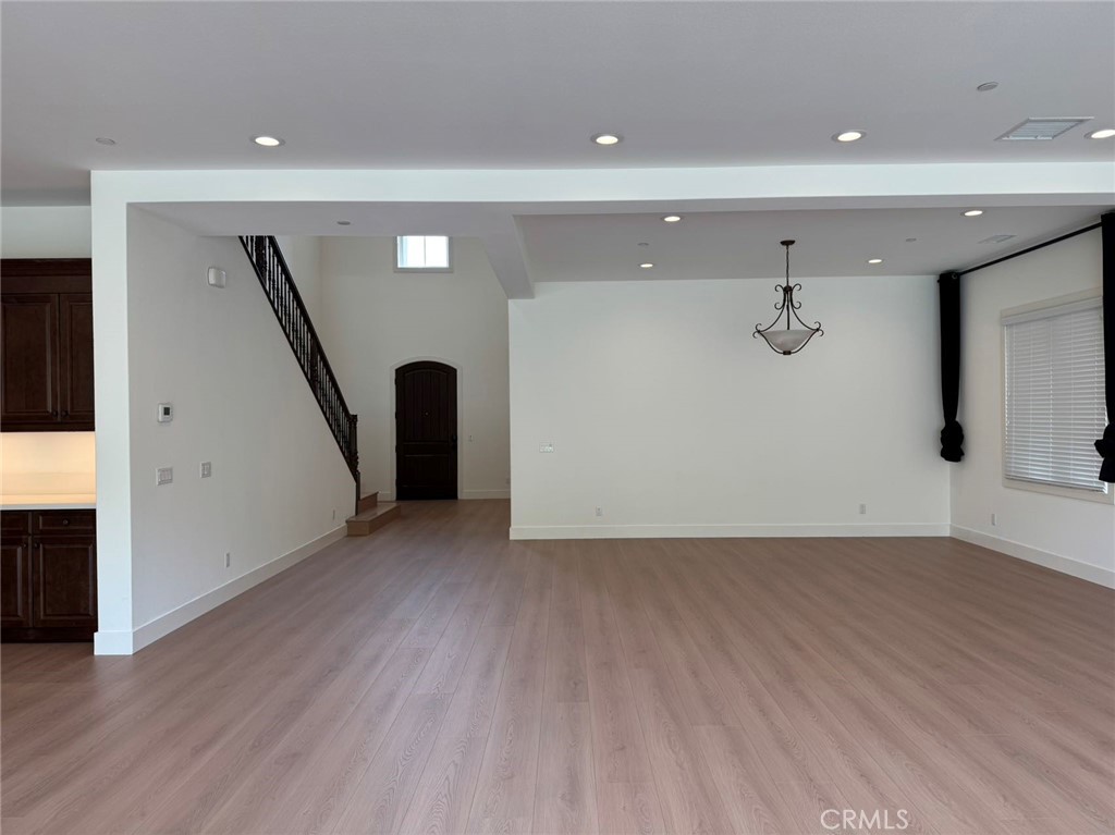101 Interstellar Irvine, CA 92618 - Photo 15 of 24 a view of an empty room with wooden floor