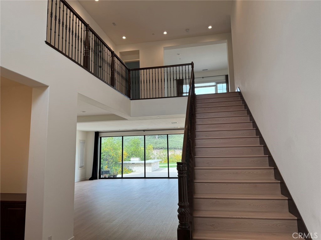 101 Interstellar Irvine, CA 92618 - Photo 17 of 24 a view of entryway and hall with wooden floor