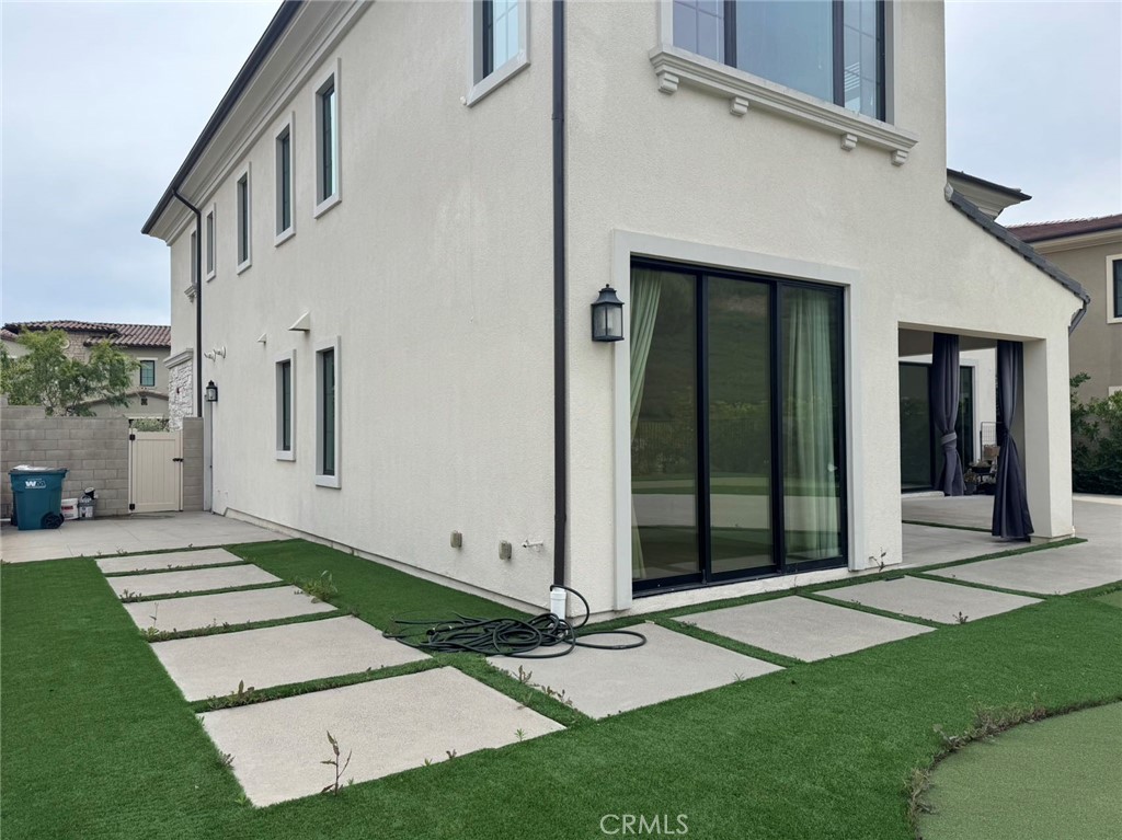 101 Interstellar Irvine, CA 92618 - Photo 18 of 24 a view of a white house with a large window and yard