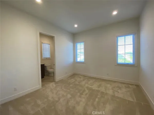 an empty room with windows and closet