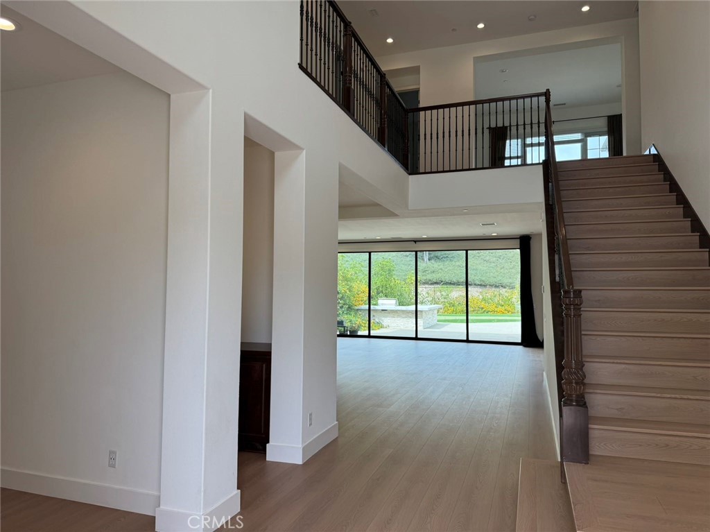 101 Interstellar Irvine, CA 92618 - Photo 2 of 24 a view of an empty room with a window and wooden floor