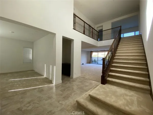 a view of a hallway with entryway and hall
