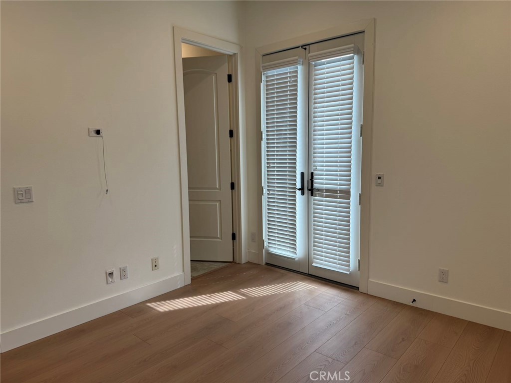 101 Interstellar Irvine, CA 92618 - Photo 21 of 24 an empty room with wooden floor and windows