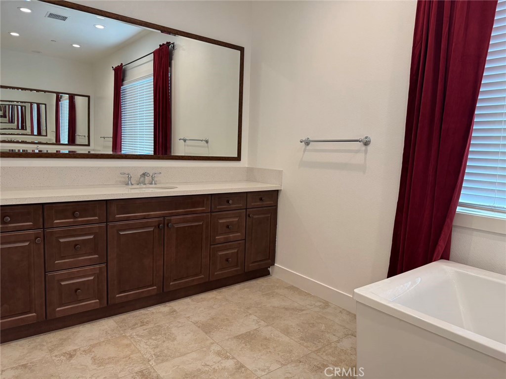 101 Interstellar Irvine, CA 92618 - Photo 23 of 24 a bathroom with a tub sink and mirror