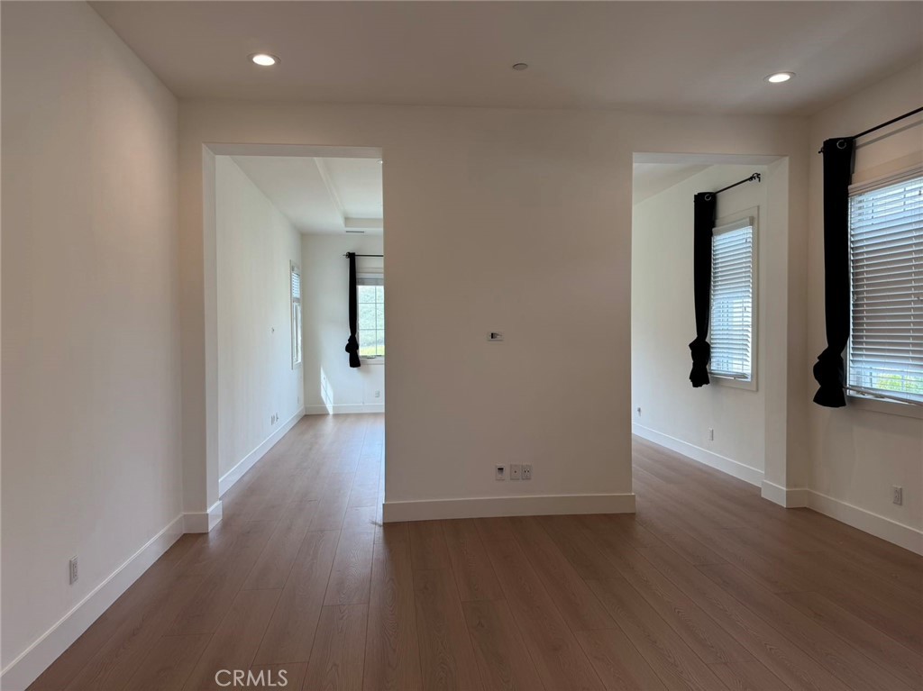 101 Interstellar Irvine, CA 92618 - Photo 24 of 24 an empty room with wooden floor and mirror