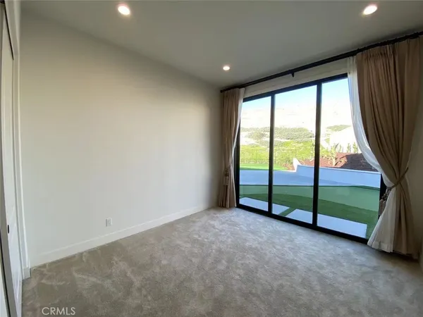 an empty room with sliding door and mountain view