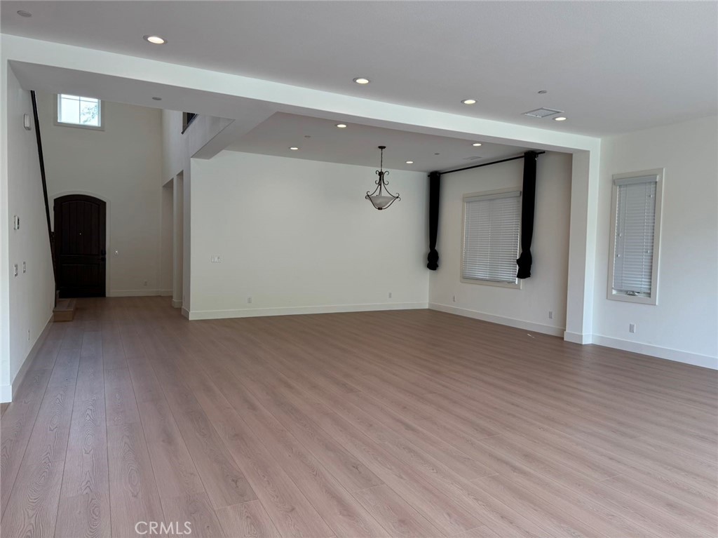 101 Interstellar Irvine, CA 92618 - Photo 6 of 24 a view of empty room with wooden floor