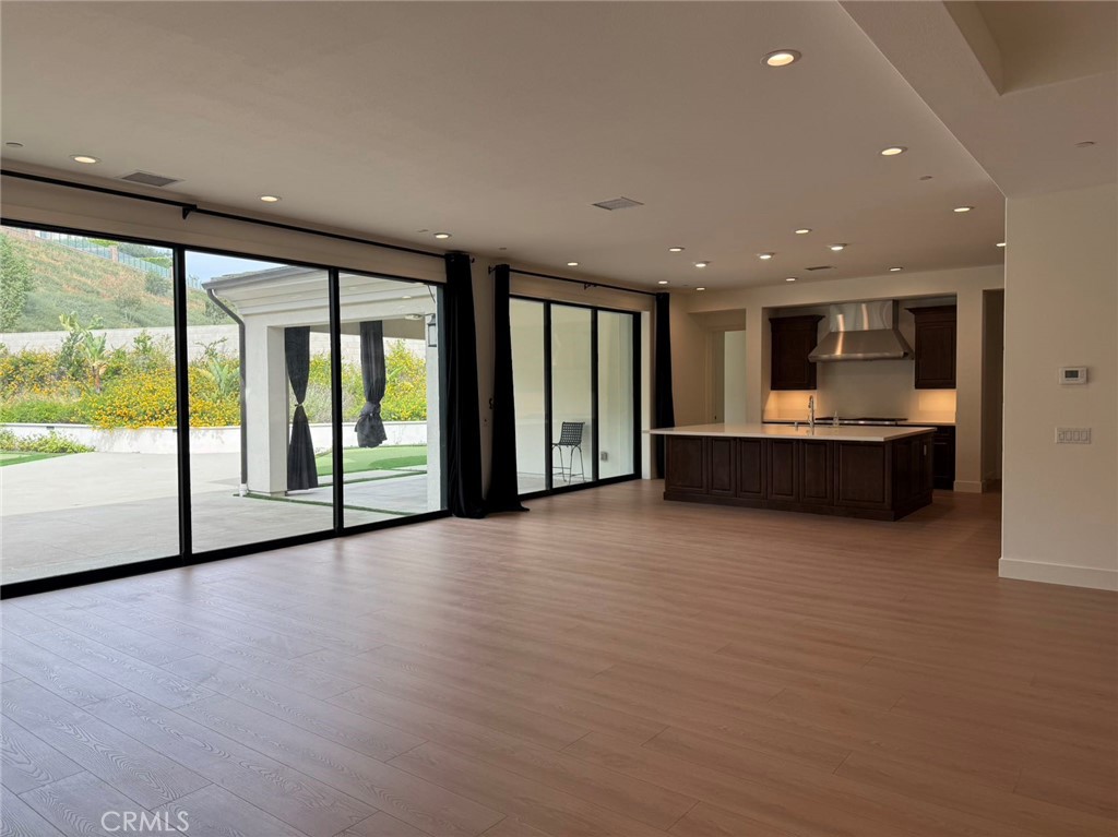 101 Interstellar Irvine, CA 92618 - Photo 10 of 24 a view of an empty room with wooden floor and a window