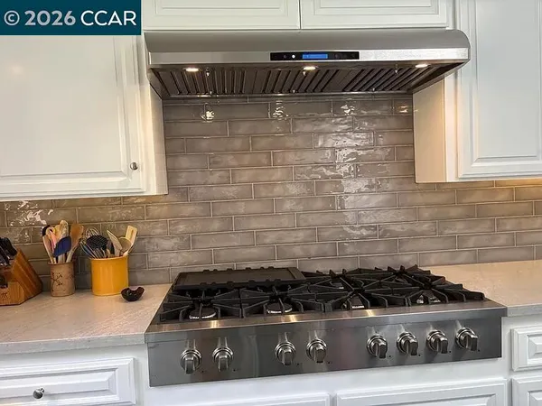a kitchen with a stove and cabinets