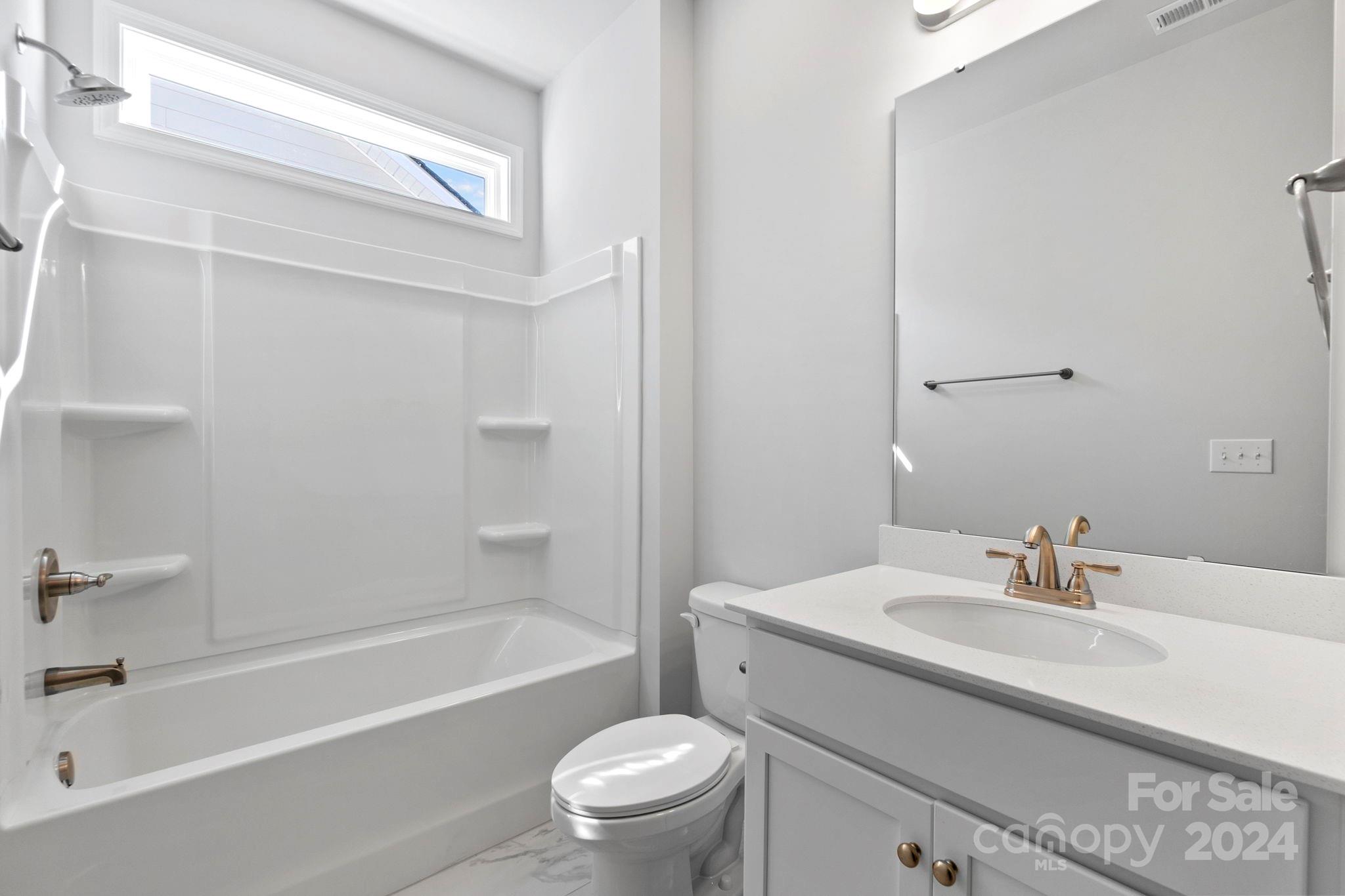 8204 Mccormick Street Terrell, NC 28682 - Photo 11 of 32 a bathroom with a sink a toilet and a bathtub