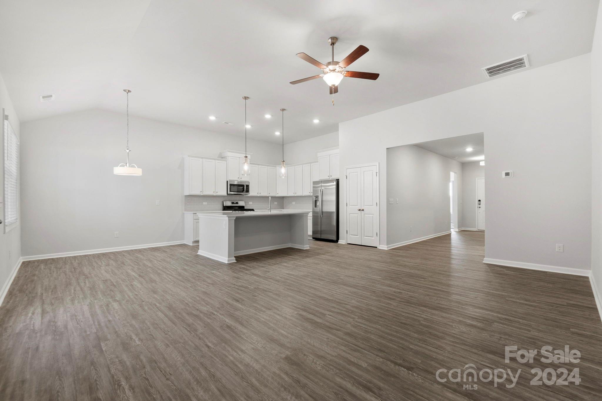 8204 Mccormick Street Terrell, NC 28682 - Photo 15 of 32 an open kitchen with a refrigerator and white cabinets
