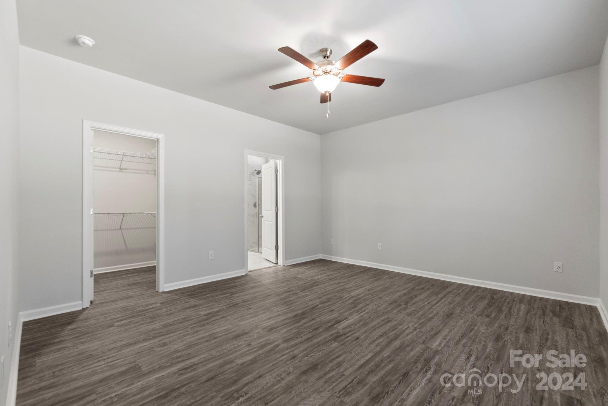 8204 Mccormick Street Terrell, NC 28682 - Photo 21 of 32 an empty room with wooden floor and ceiling fan