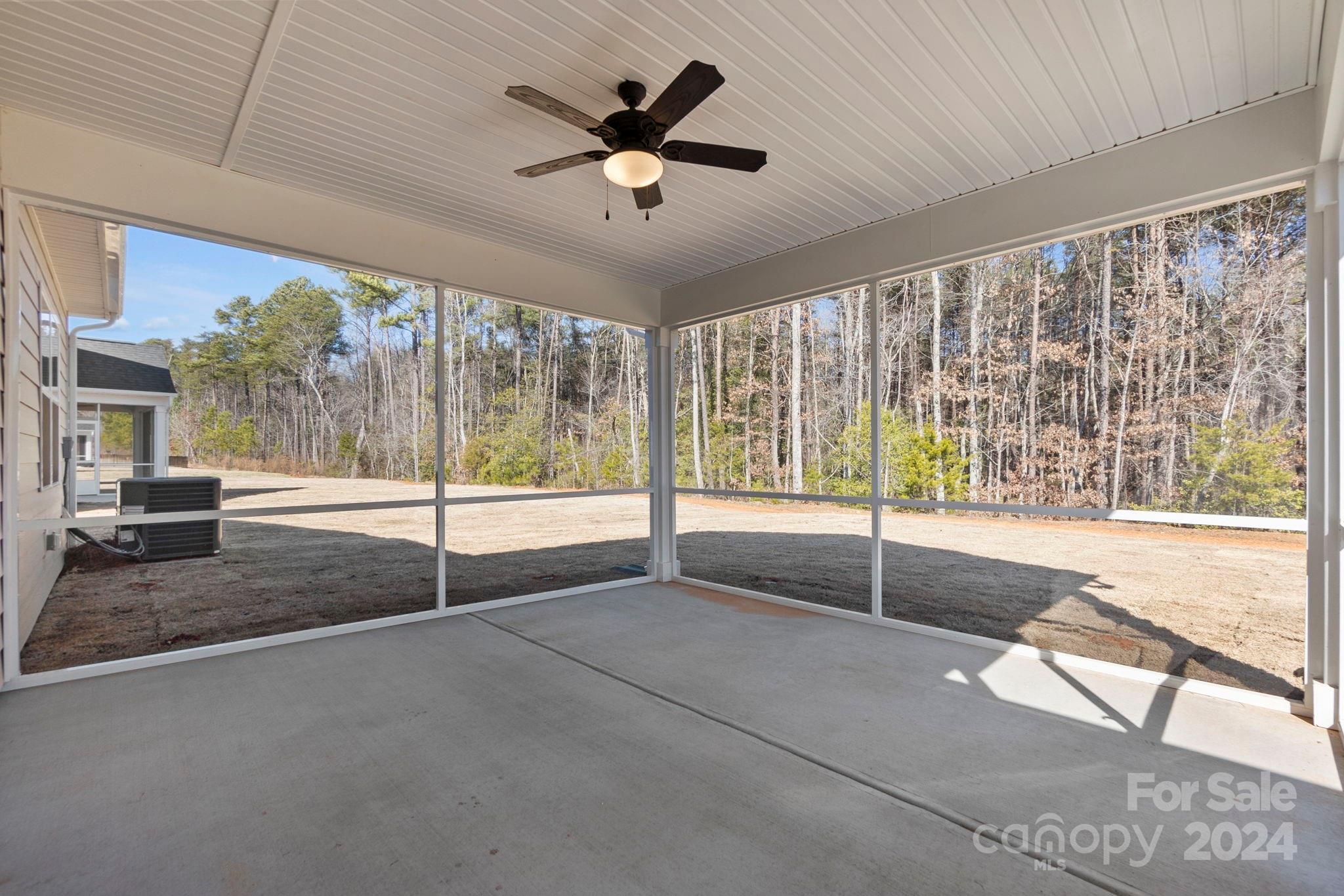 8204 Mccormick Street Terrell, NC 28682 - Photo 6 of 32 a view of an empty room with wooden floor and a ceiling fan