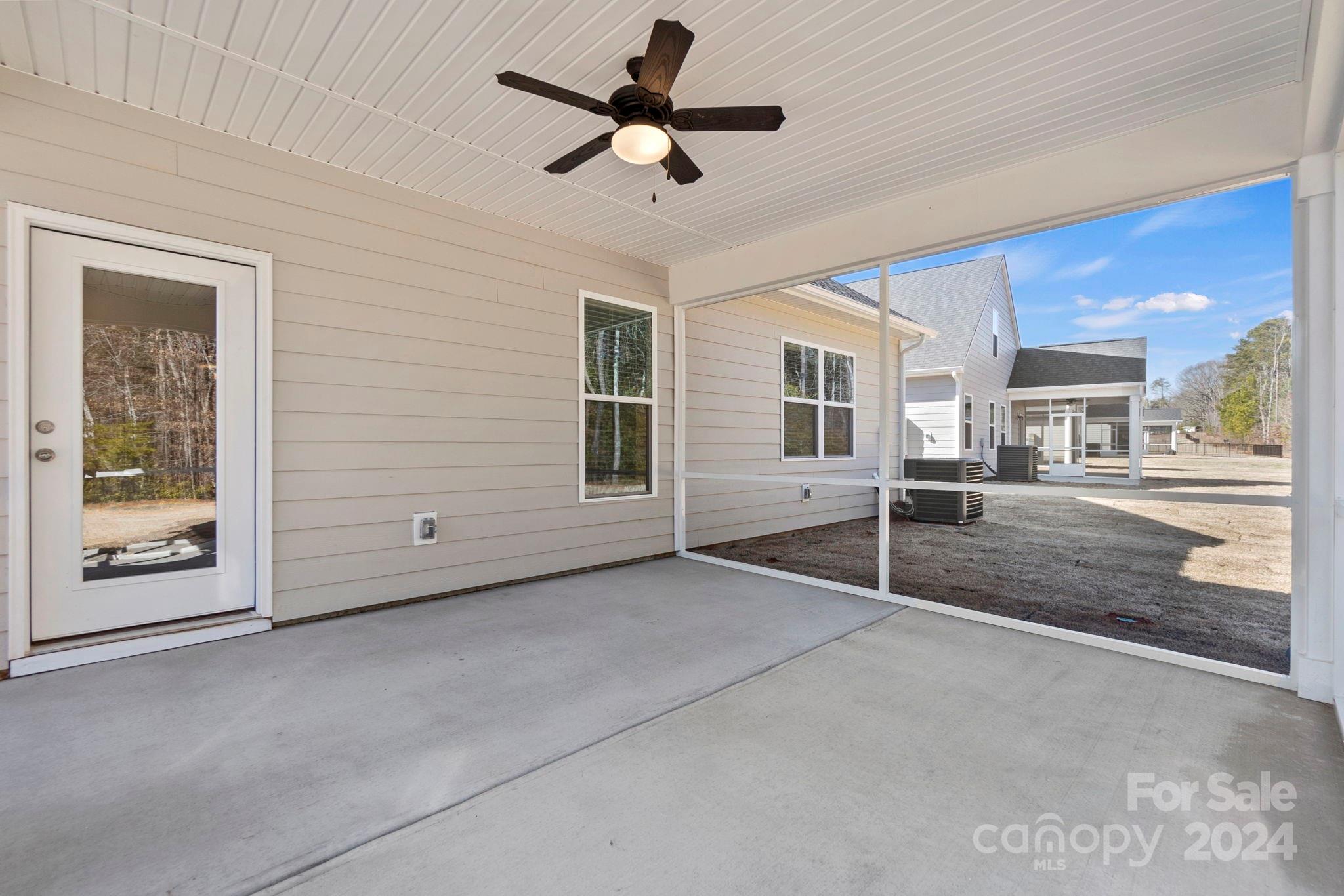 8204 Mccormick Street Terrell, NC 28682 - Photo 7 of 32 a view of a livingroom with a furniture ceiling fan and window