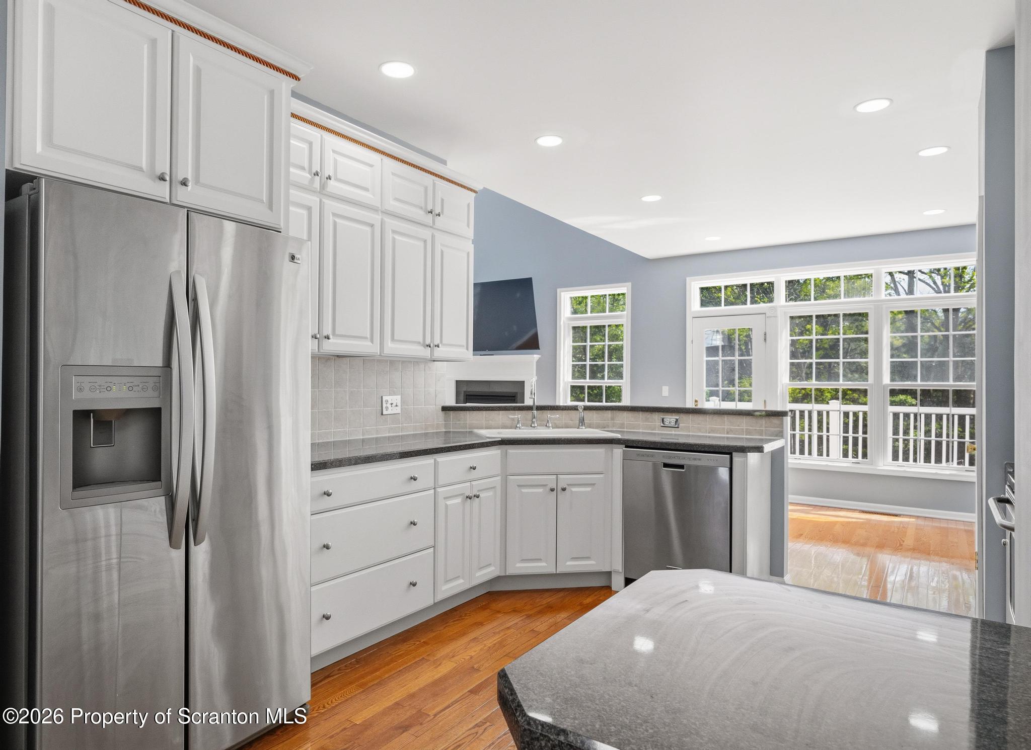 1502 Verne Cl Moosic, PA 18507 - Photo 11 of 46 a very nice looking kitchen with granite countertop a stove top oven a sink and a refrigerator
