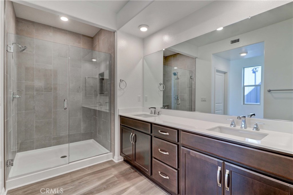 130 Spectacle Irvine, CA 92618 - Photo 16 of 38 a bathroom with a shower sink double and mirror