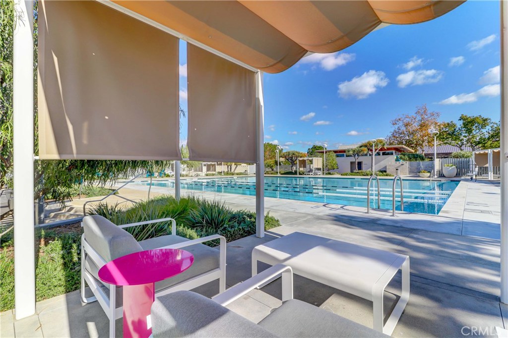 130 Spectacle Irvine, CA 92618 - Photo 32 of 38 a view of a chair and tables in the back yard of the house