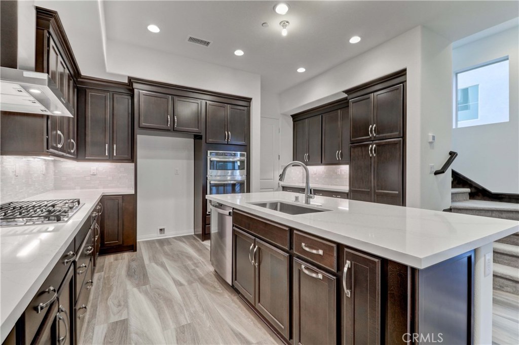 130 Spectacle Irvine, CA 92618 - Photo 5 of 38 a kitchen with stainless steel appliances granite countertop a sink stove and refrigerator