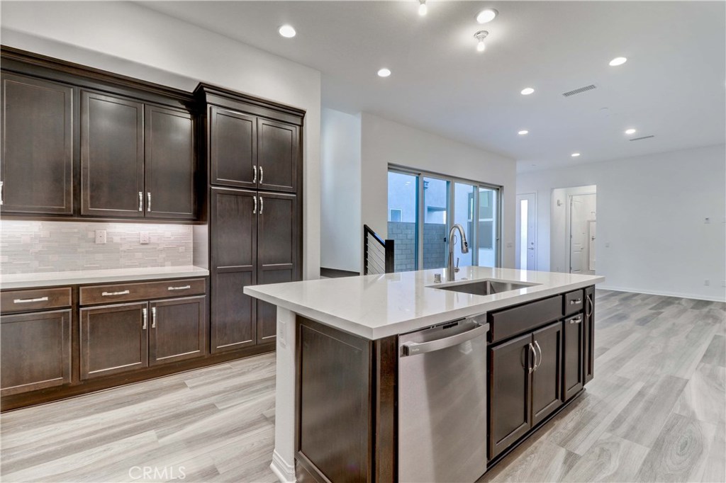 130 Spectacle Irvine, CA 92618 - Photo 6 of 38 a kitchen with stainless steel appliances granite countertop a sink stove and refrigerator