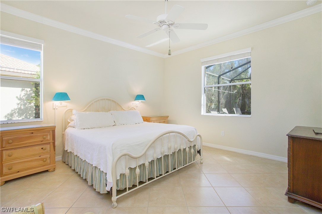 7948 Princeton Drive Naples, FL 34104 - Photo 12 of 35 a bedroom with a bed table and window