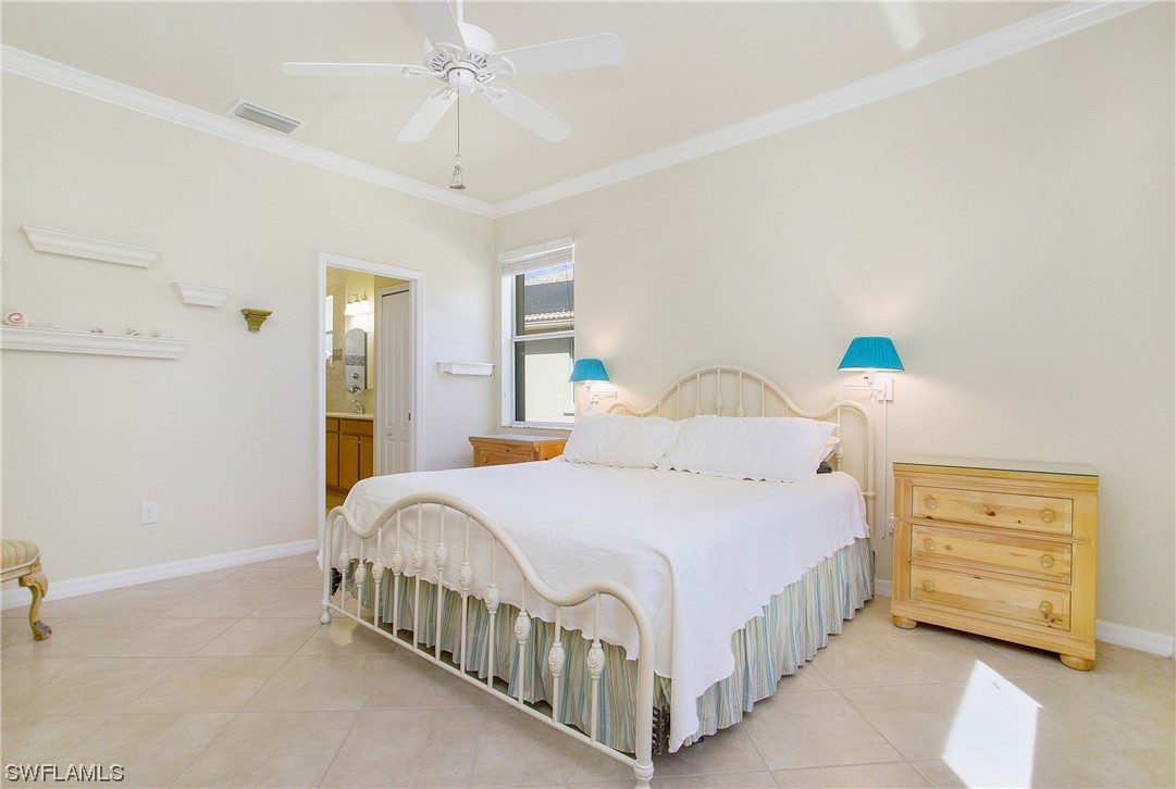 7948 Princeton Drive Naples, FL 34104 - Photo 13 of 35 a bedroom with a bed and a night stand