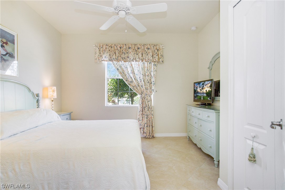7948 Princeton Drive Naples, FL 34104 - Photo 22 of 35 a bedroom with a bed and a window