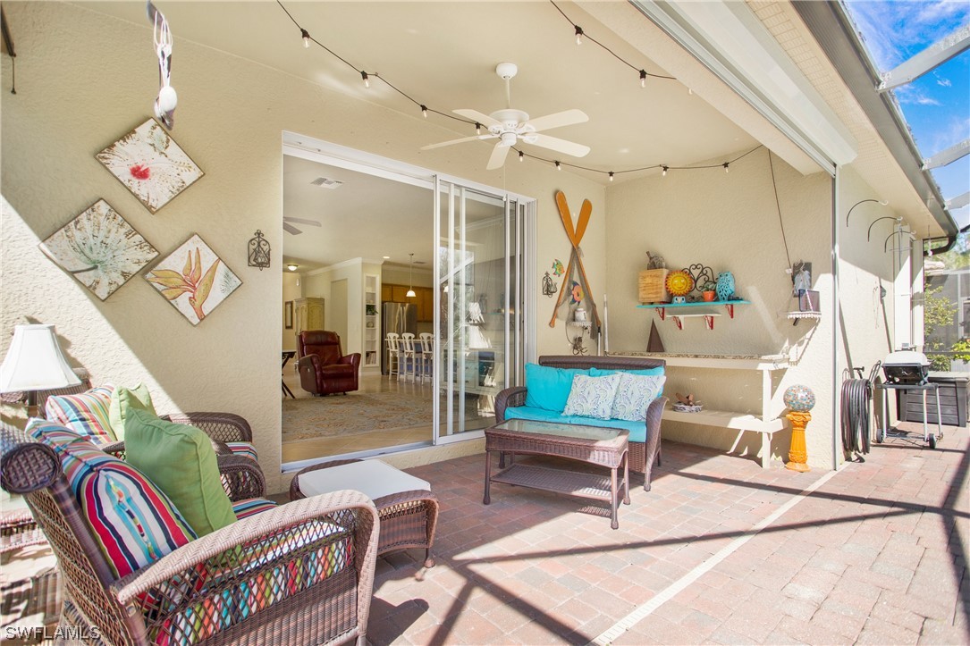 7948 Princeton Drive Naples, FL 34104 - Photo 27 of 35 a reading room with furniture and a chandelier