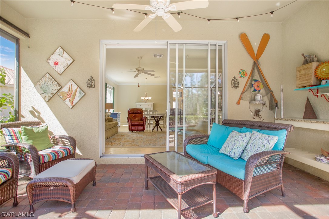 7948 Princeton Drive Naples, FL 34104 - Photo 28 of 35 a living room with furniture and a large window