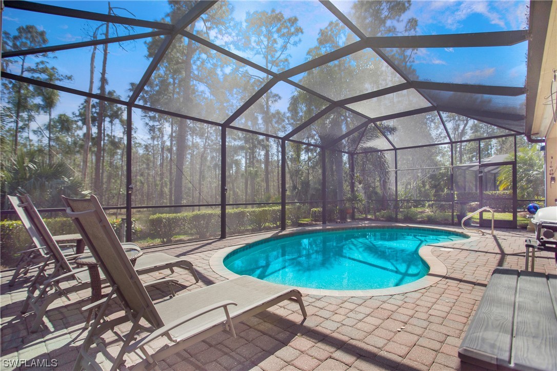 7948 Princeton Drive Naples, FL 34104 - Photo 29 of 35 a view of a swimming pool with a patio