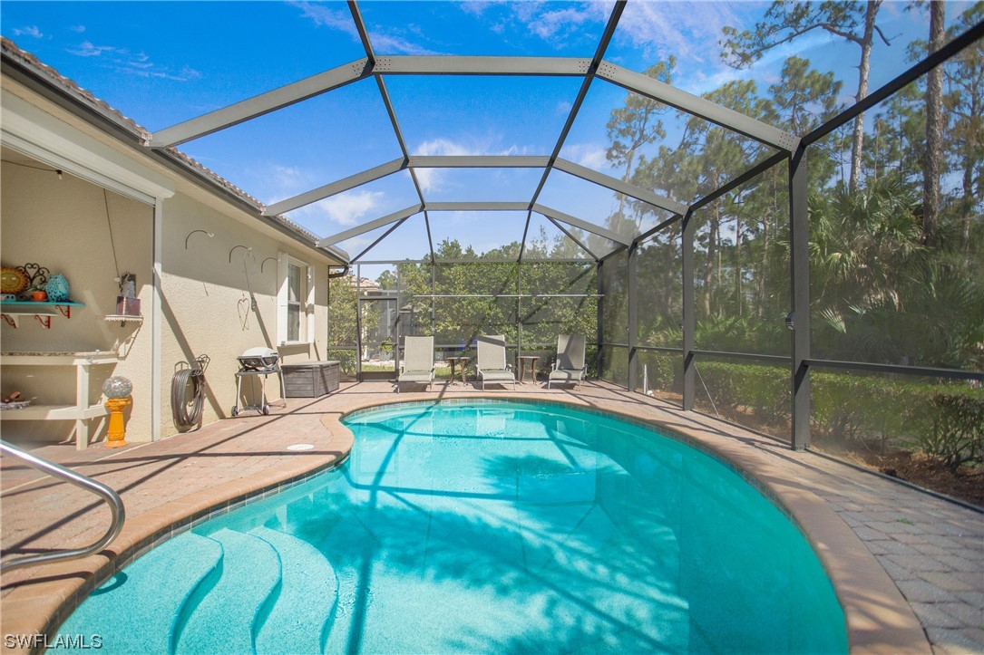 7948 Princeton Drive Naples, FL 34104 - Photo 31 of 35 a view of a swimming pool with a patio