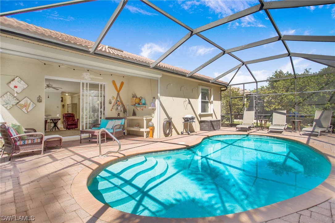 7948 Princeton Drive Naples, FL 34104 - Photo 32 of 35 a view of a swimming pool with a patio