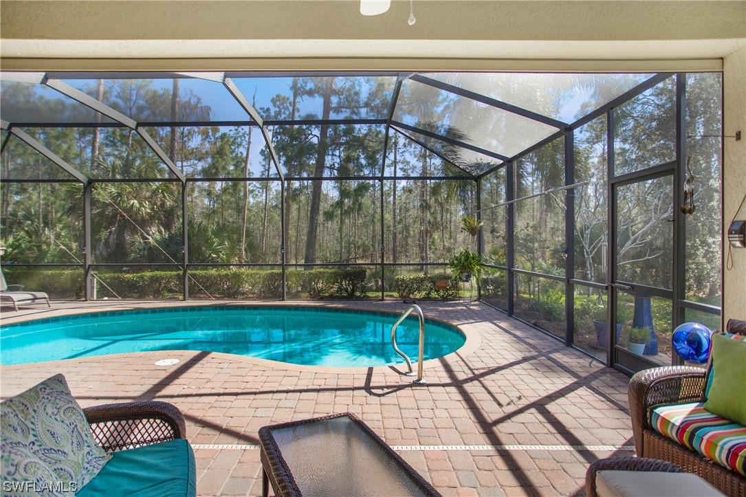7948 Princeton Drive Naples, FL 34104 - Photo 33 of 35 a patio with a yard table and chairs