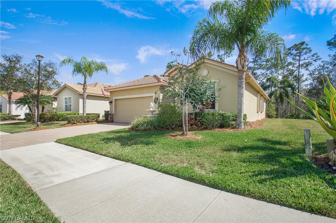 7948 Princeton Drive Naples, FL 34104 - Photo 35 of 35 a view of a house with a yard and palm trees