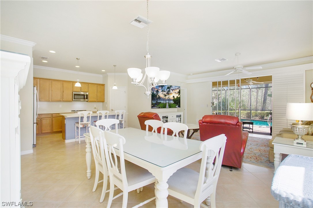 7948 Princeton Drive Naples, FL 34104 - Photo 7 of 35 a dining room filled counter top space and a kitchen view